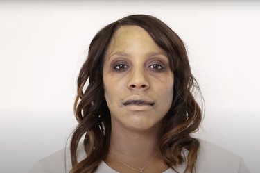 A woman wearing zombie makeup