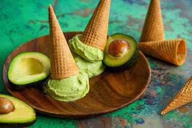 Beautiful scoops of green avocado ice cream and sugar cones