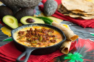 A dish with melty, gooey queso fundido with cactus and soy chorizo