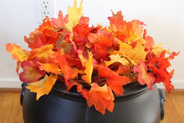 Fall leaf garland in top of cauldron.