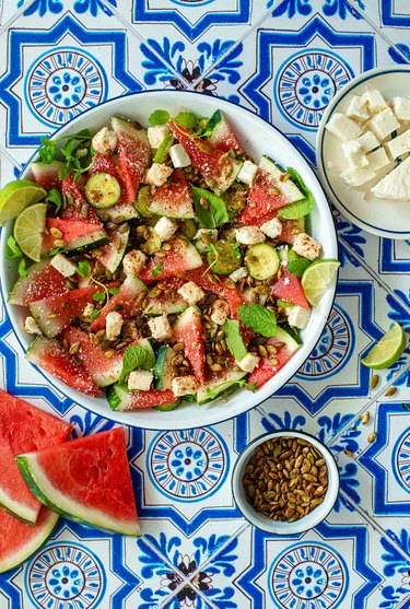 Watermelon salad against a blue tiled background