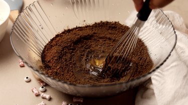 Whisking egg and cocoa powders into dough batter