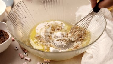 Mixing melted butter and sugars in large bowl