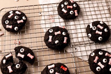 Monster cookies on wire rack with eyeball sprinkles and bone sprinkles