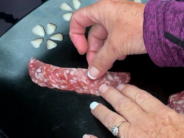 lining up halved salami pieces
