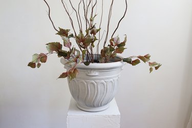 Fall planter with faux leaves and willow branches