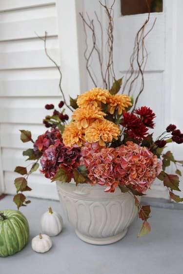 Fall planter with fall florals and leaves