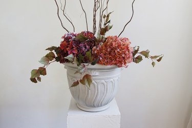 Fall planter with faux autumnal florals on pedestal