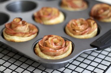 Blooming flower apple pies in a muffin pan