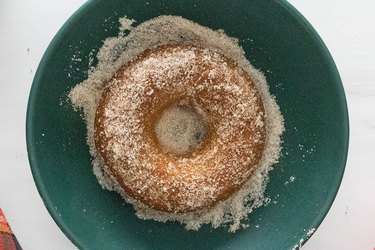 Apple cider donut coated in cinnamon sugar