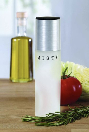 Frosted glass bottle with a silver cap that says "MISTO" on it in black lettering.