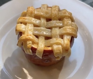 Apple pie dough lattice atop halved apple
