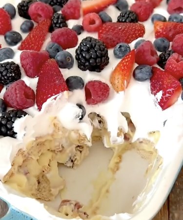Layered ice box cake topped with mixed berries
