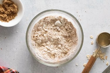 Flour, oats, brown sugar, and cinnamon in a bowl