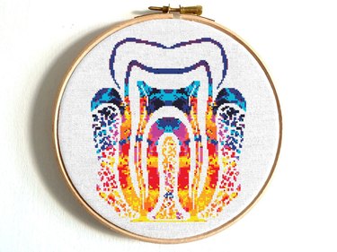 Cross-stitch shaped like a tooth in vibrant shades of orange, red, purple and blue
