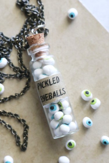 Glass bottle necklace filled with clay eyeballs