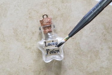 Applying potion label to star bottle pendant