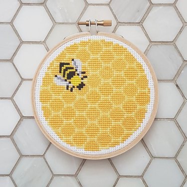 All-over yellow cross-stitch with bee