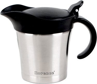 A stainless steel carafe with a black plastic handle and hinged lid