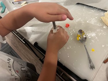 boy's hands making mooncake with mold