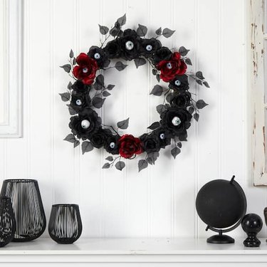 24" Eyeball Rose Halloween Artificial Wreath above a fireplace mantel. The eyeballs are pointed in different directions.