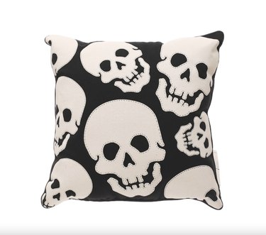 Black and white skull motif throw pillow with visible stitching.