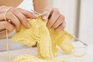 Woman knitting flower petal bib