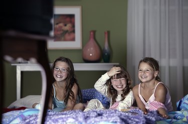 Girls watching television and laughing