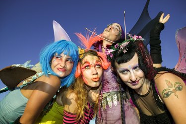 Women wearing fairy costumes posing together