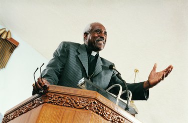 Low Angle View of a Priest Preaching From a Church Pulpit During a Service