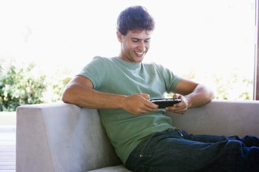 Man playing handheld video game