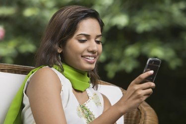 Smiling woman using cellular phone
