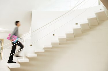 Blurred Motion Shot of a Man Ascending a Stairway in a Modern Home