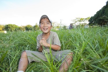 Boy sitting on grass, Japan