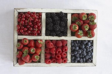 Assorted berry fruits in container, view from above