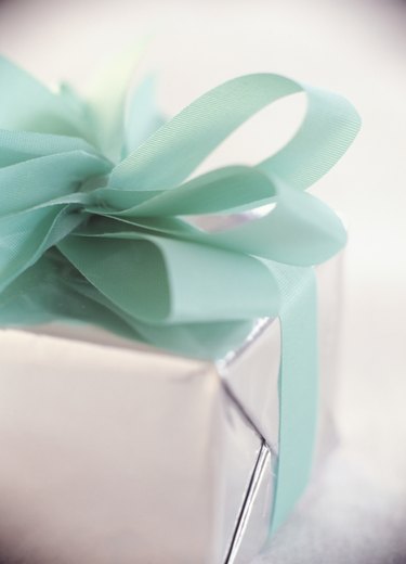 Christmas gift wrapped with bow, close-up