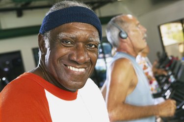 Senior man in gym, smiling, portrait, close-up