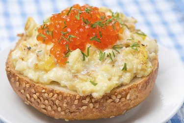 scramble eggs with red caviar on a wheat bun