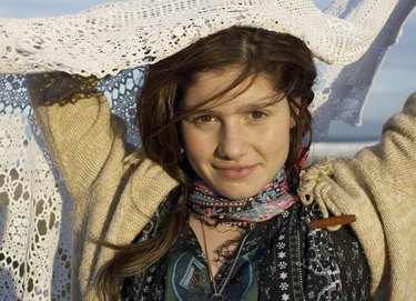 Portrait of teenage girl (16-17) holding shawl, smiling