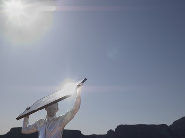 Young man with solar panel, portrait