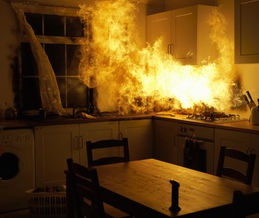 Fire raging in domestic kitchen at night