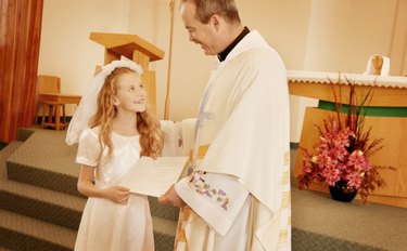Child receives certificate from Priest