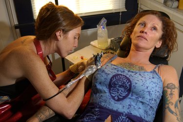 Woman getting tattoo