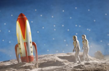 Astronaut figurines and toy rocket