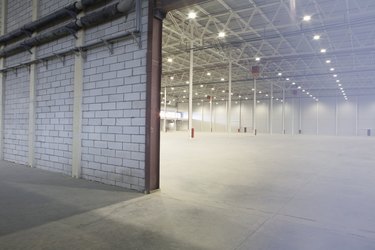 Access door to brightly lit and empty warehouse