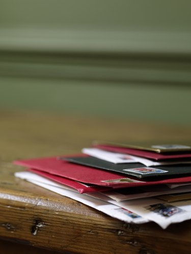 Pile of Christmas cards and letters sits on table