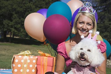 Woman and poodle with gifts and balloons