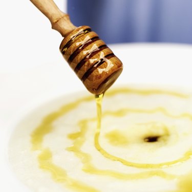 Close-up of honey dribbling on a dessert