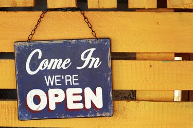 Old weathered yellow wood signboard - Stock Image