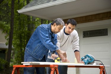 Mature man working with son 